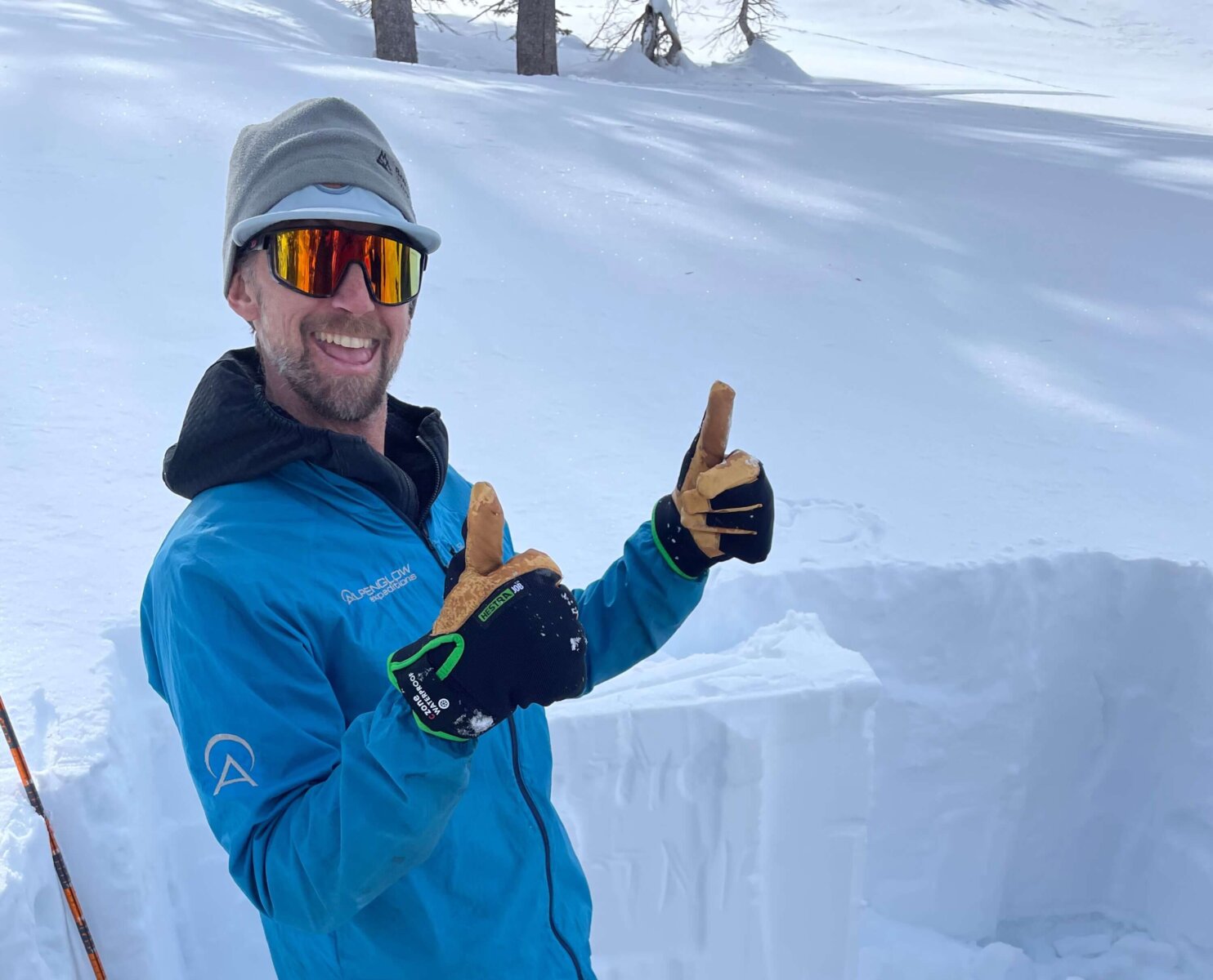 backcountry ski guide digging snow pit
