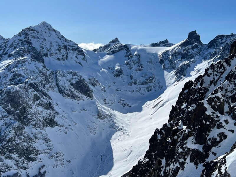 Backcountry skiers descending a glaciated slope in Patagonia during an Alpenglow Expeditions guided ski expedition in Chile
