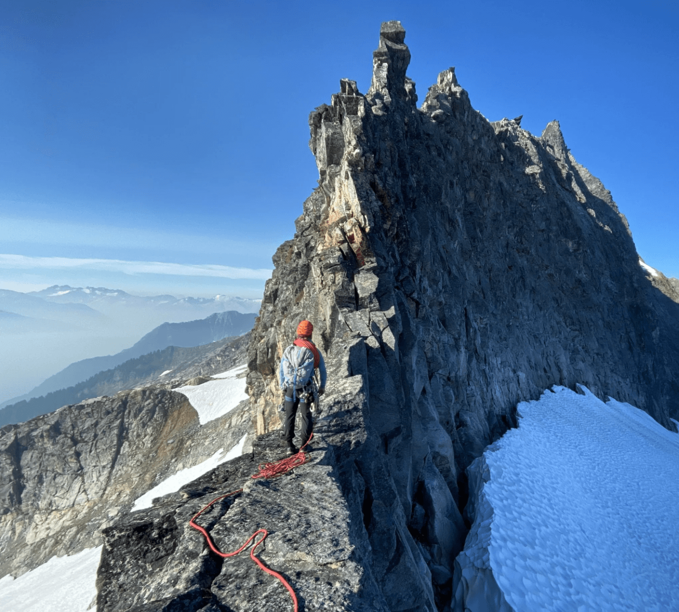Two climbers route finding up a class 5 ridge on an alpine climb
